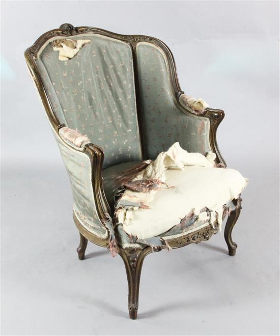 A Louis XV style armchair, late 19th century, covered in striped blue silk